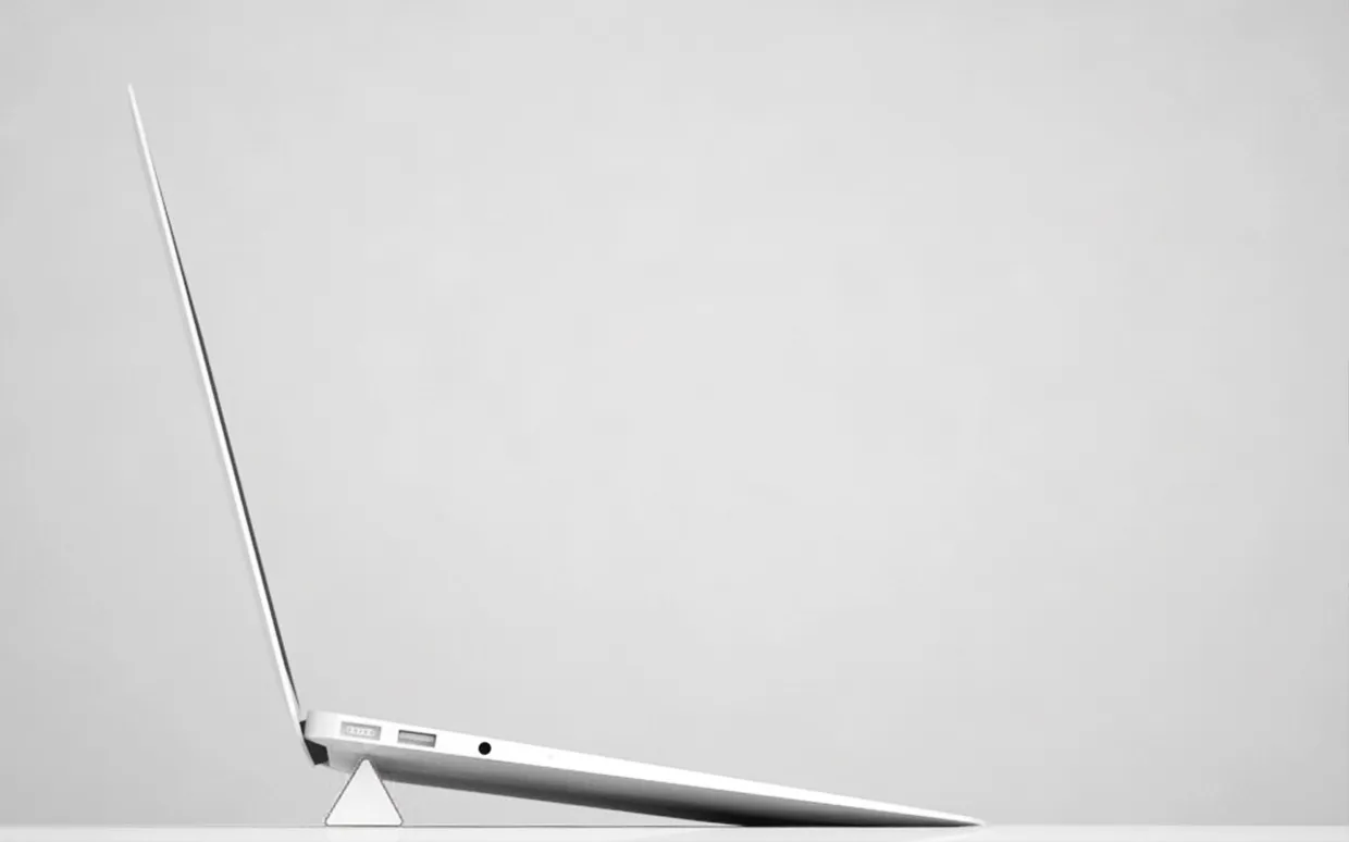 A laptop lifted at the back by the ruler, with air underneath